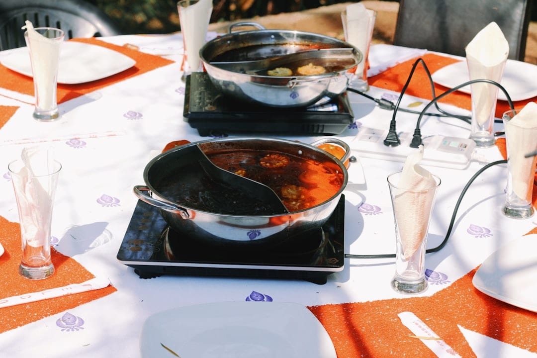 Sichuan hotpot with bubbling broth and fresh ingredients on a dining table