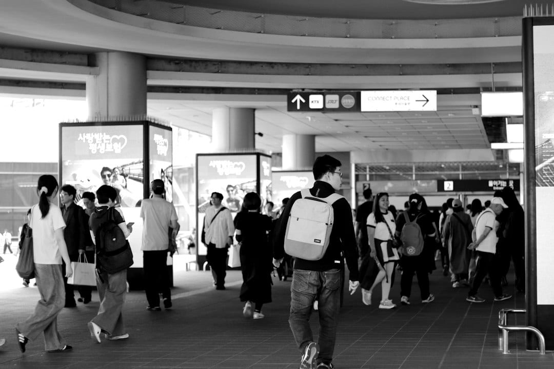 People walking through a busy modern concourse